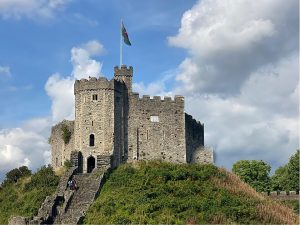 Decorative image: a stone castle atop a hill