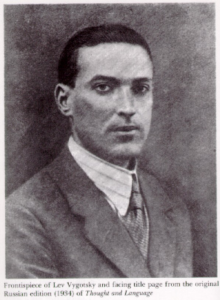 Grayscale shaded image of a man with short hair wearing a suit and tie