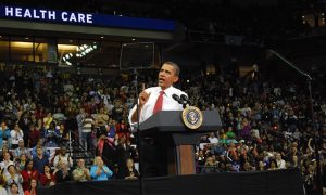 he picture is a photograph of President Barack Obama giving a speech on healthcare reform.
