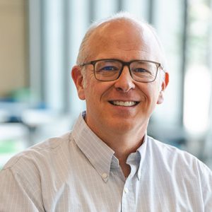 David Wiley, a white man wearing square glasses and smiling.